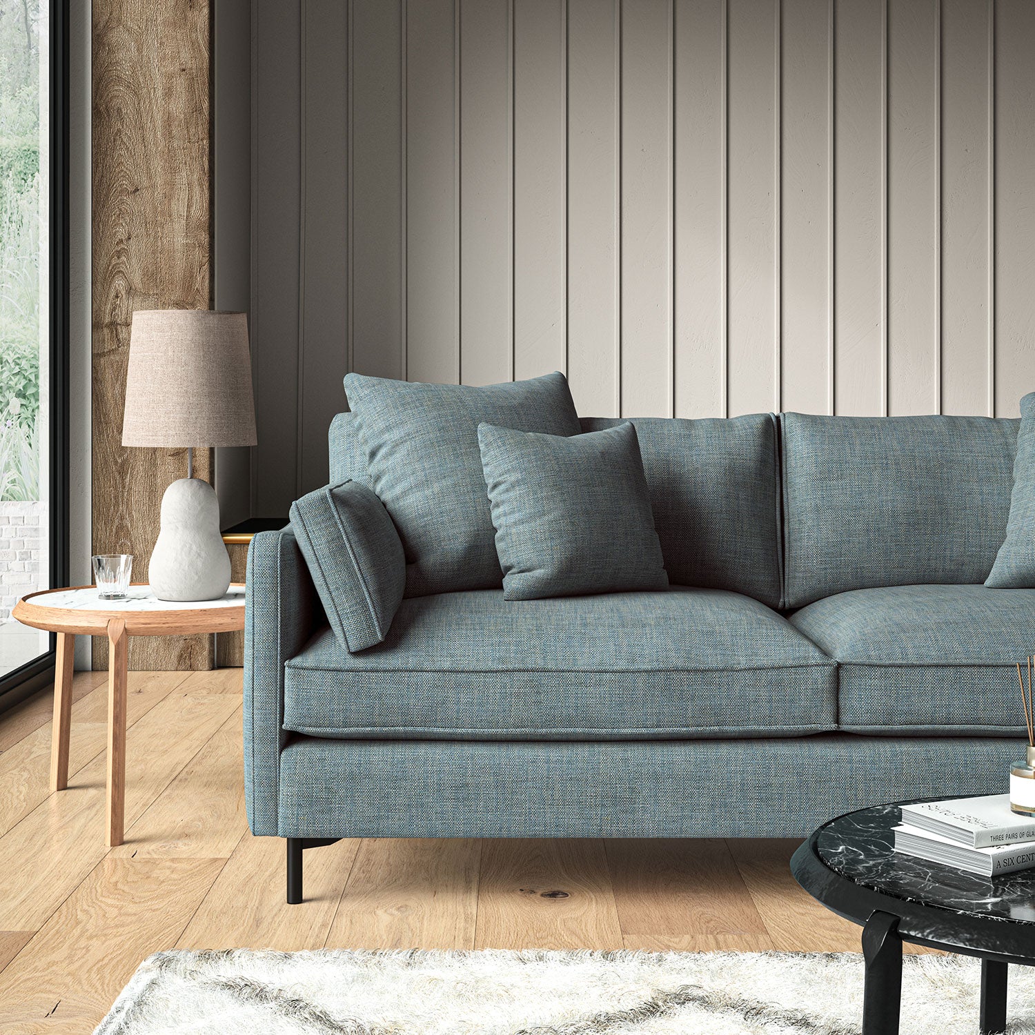 Blue sofa upholstered in a chenille woven fabric.