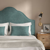 Blue headboard upholstered in a chenille woven fabric.