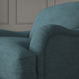 Blue chair upholstered in a chenille woven fabric.