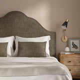 Brown headboard upholstered in a chenille woven fabric.