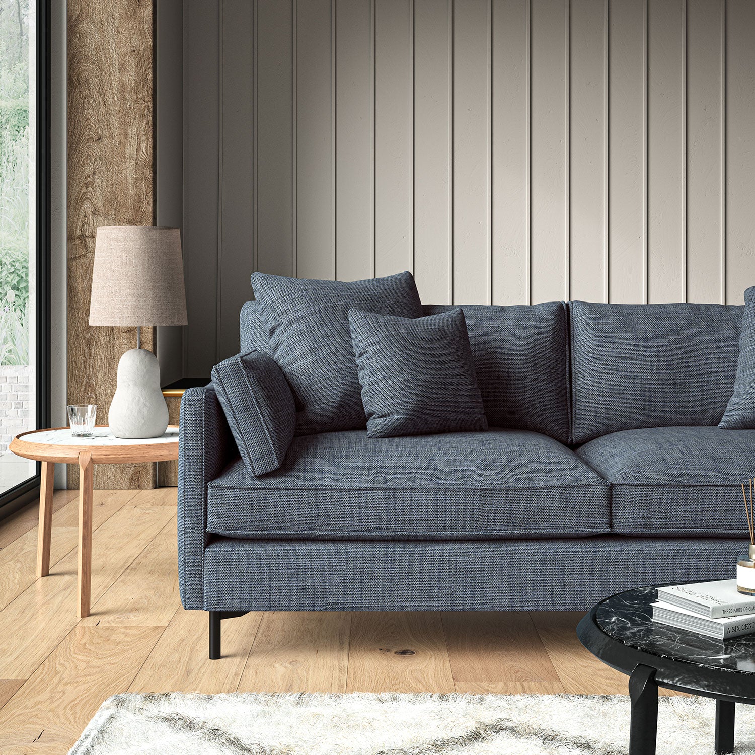 Blue sofa upholstered in a chenille woven fabric.