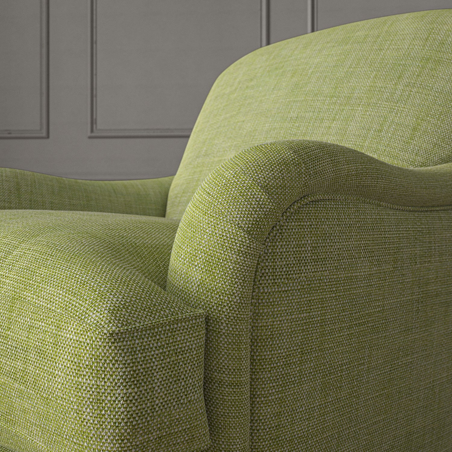 Green chair upholstered in a chenille woven fabric.