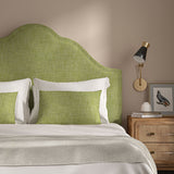 Green headboard upholstered in a chenille woven fabric.