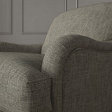 Grey chair upholstered in a chenille woven fabric.