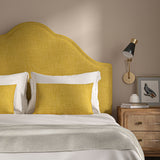 Yellow headboard upholstered in a chenille woven fabric.