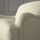 Cream chair upholstered in a chenille woven fabric.