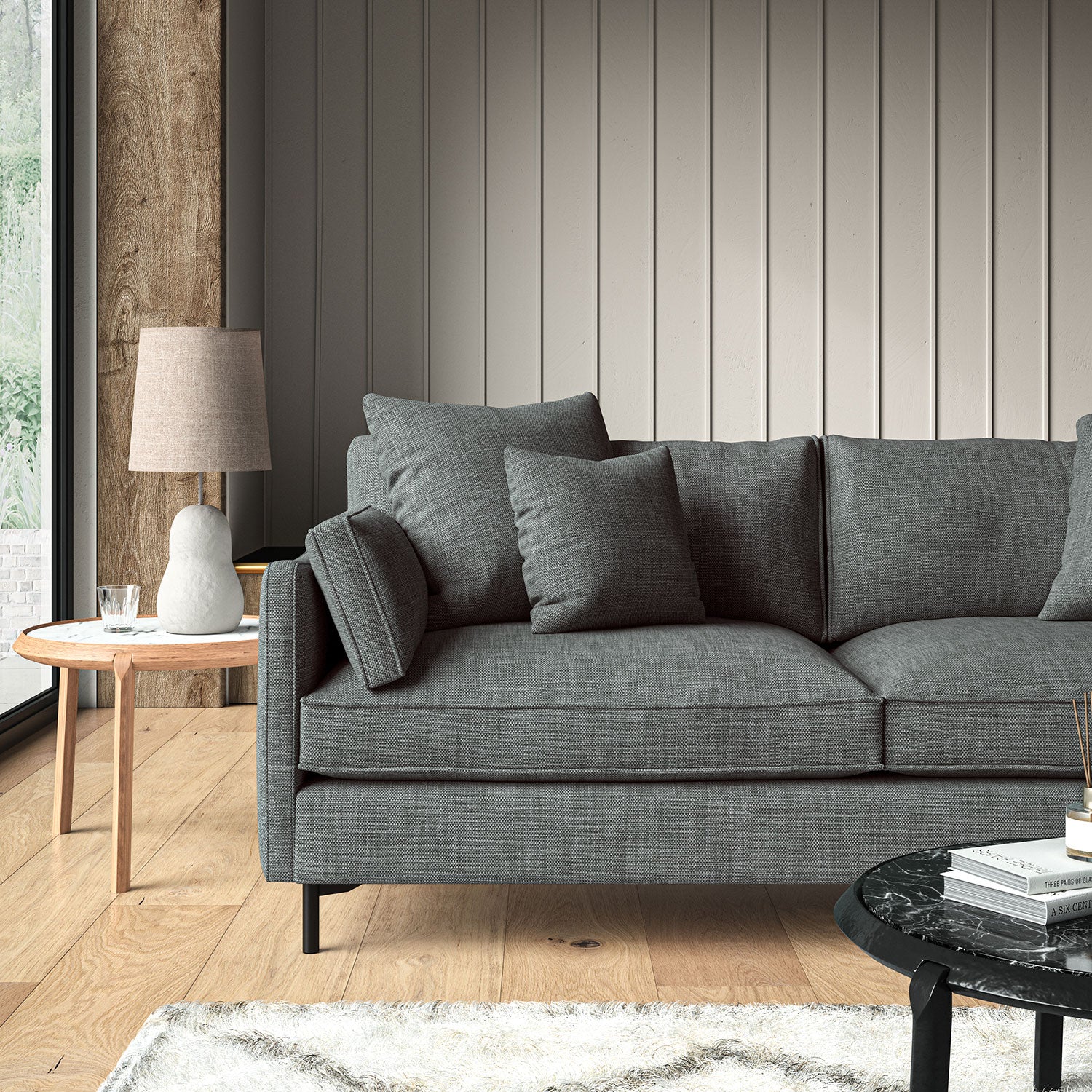 Blue sofa upholstered in a chenille woven fabric.