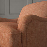 Orange chair upholstered in a chenille woven fabric.