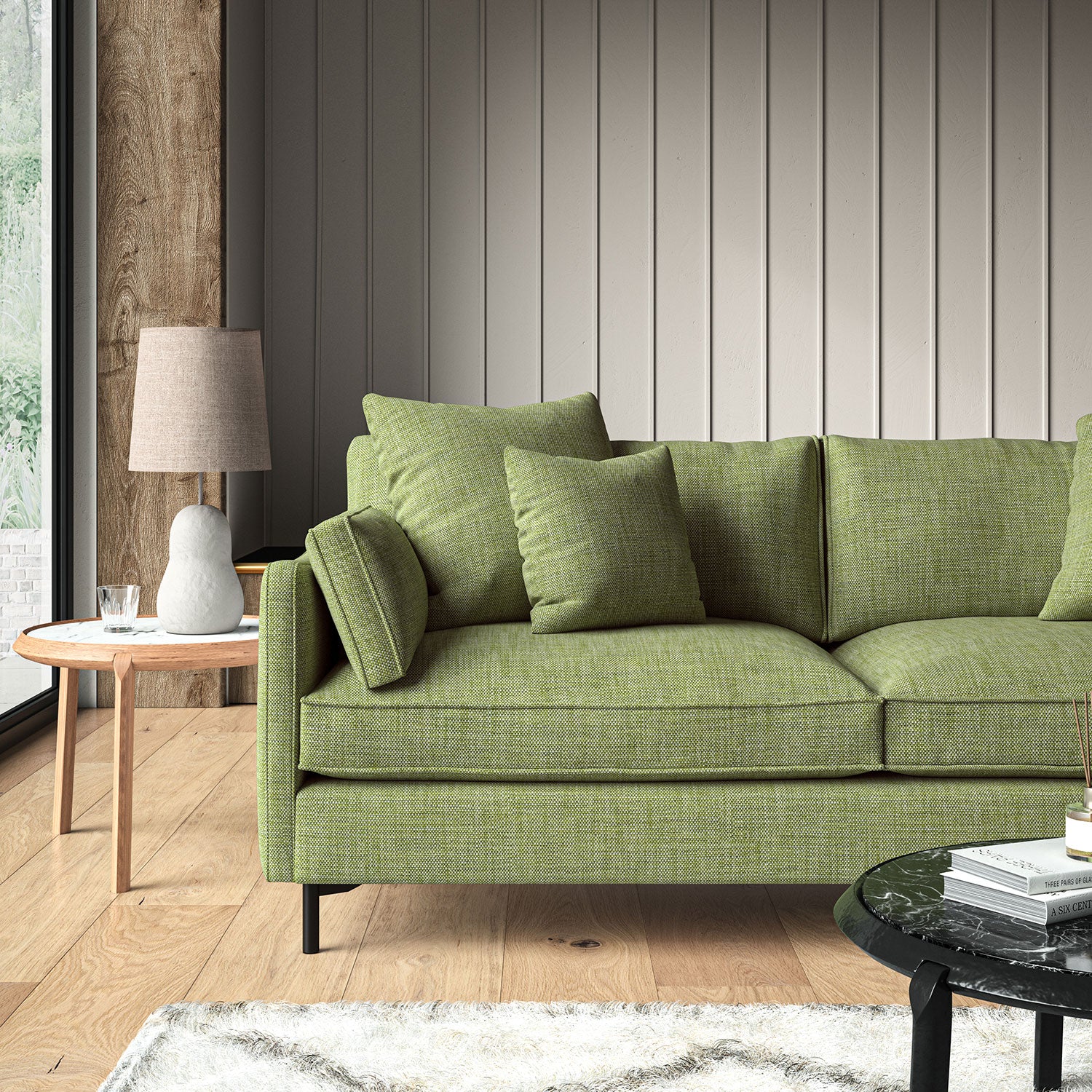 Green sofa upholstered in a chenille woven fabric.