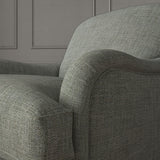 Grey chair upholstered in a chenille woven fabric.