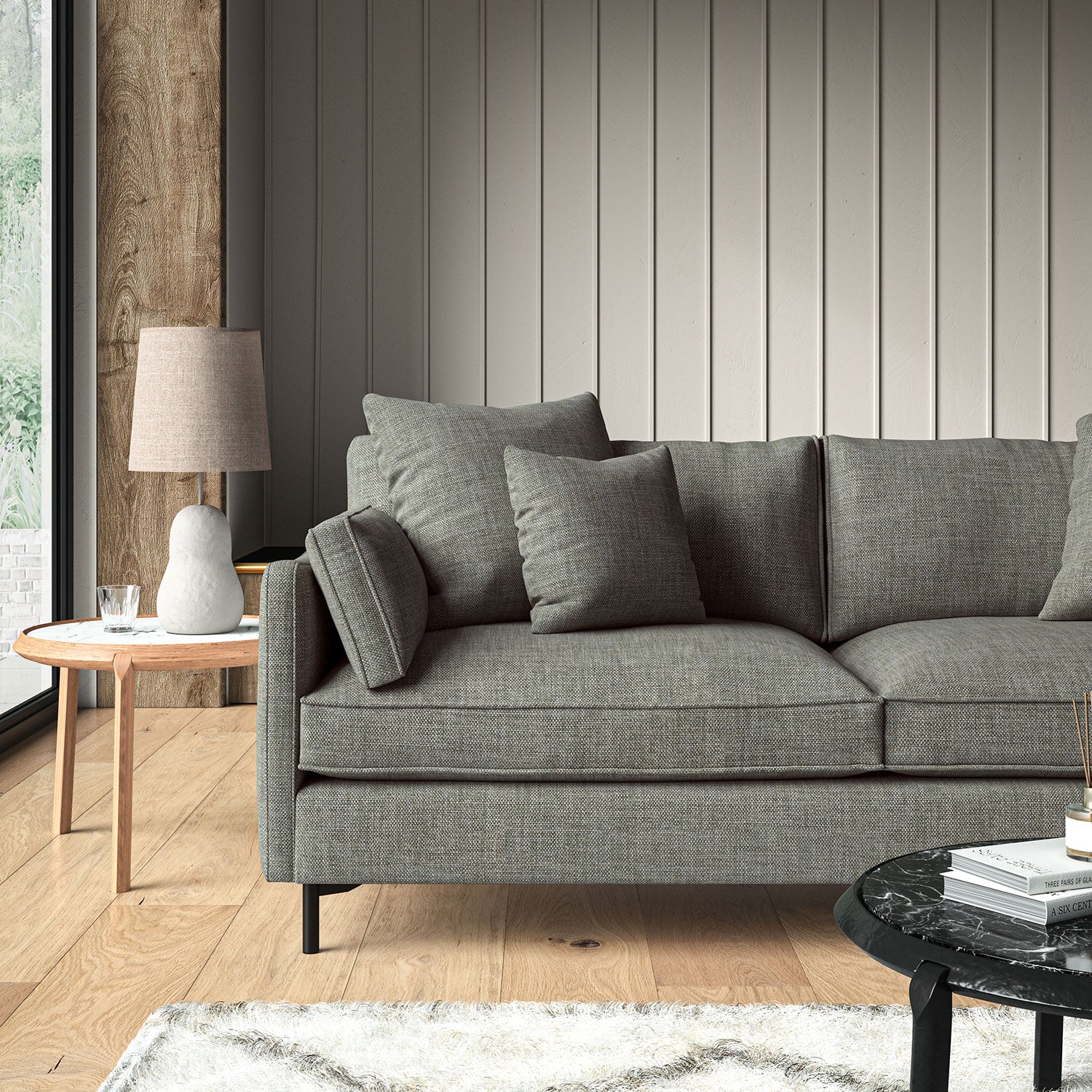 Grey sofa upholstered in a chenille woven fabric.