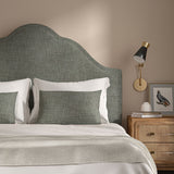 Grey headboard upholstered in a chenille woven fabric.