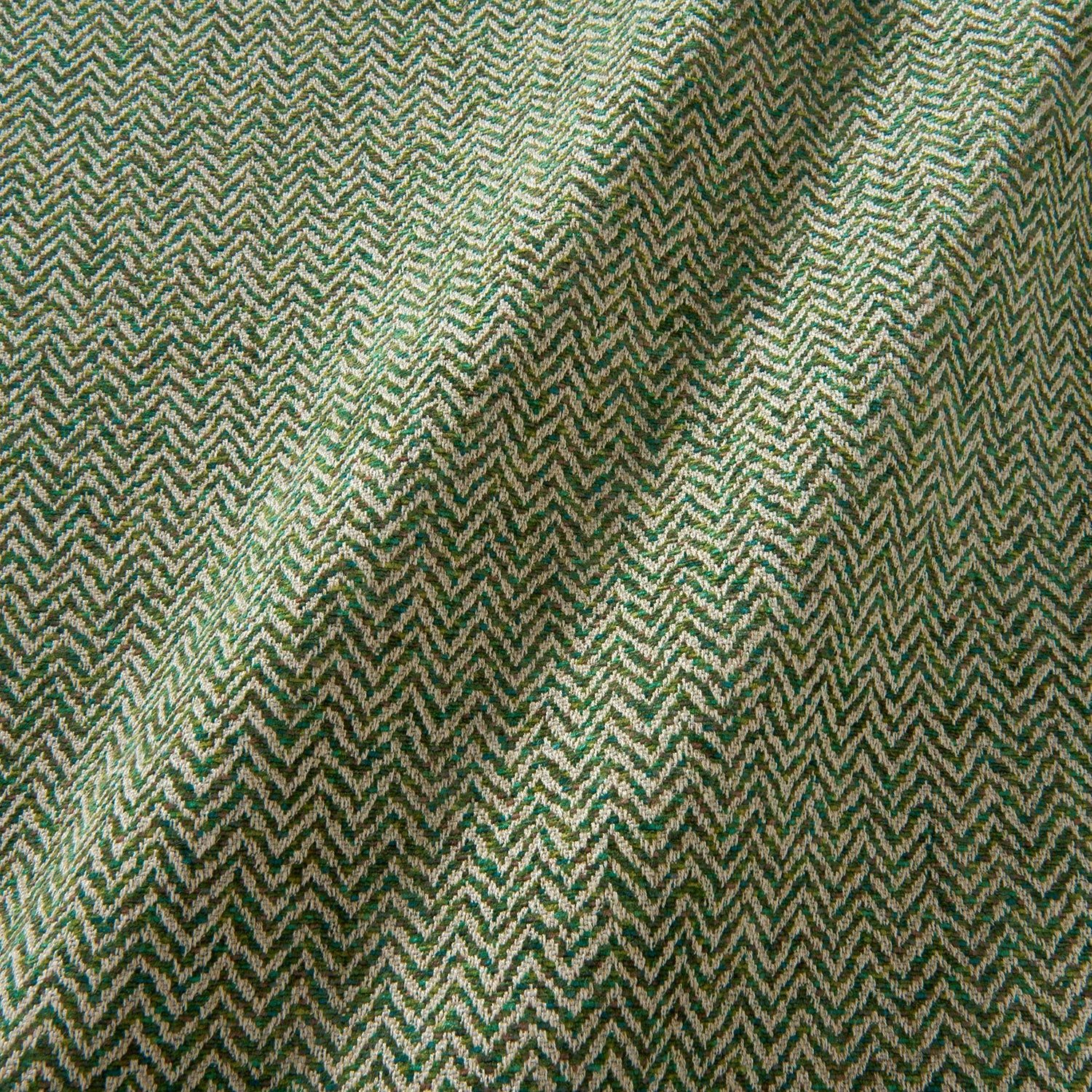A woven fabric sample in green and off-white featuring a herringbone pattern.