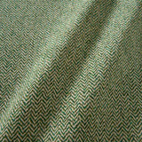 A woven fabric sample in green and off-white featuring a herringbone pattern.