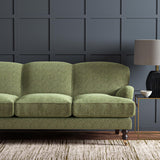 Sofas upholstered in a green and off-white woven fabric featuring a herringbone pattern.