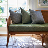 Cushions upholstered in a green and off-white woven fabric featuring a herringbone pattern.