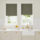 Blinds in grey and off-white woven fabric featuring a herringbone pattern.