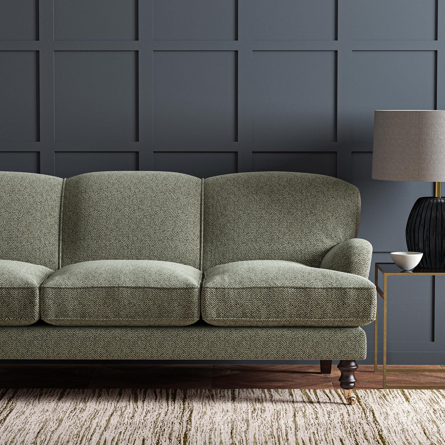Sofa upholstered in a grey and off-white woven fabric featuring a herringbone pattern.
