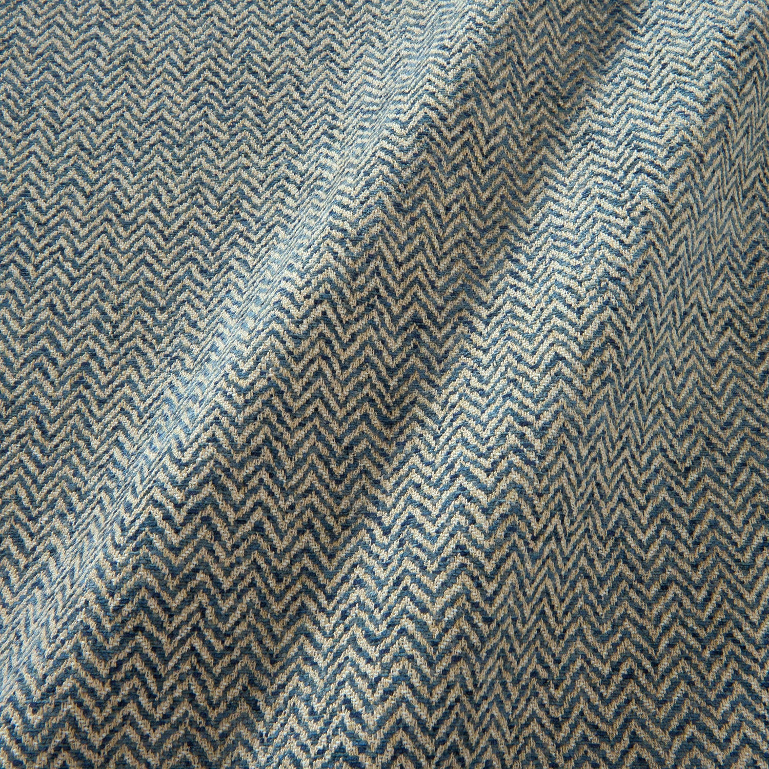 A woven fabric sample in blue and off-white featuring a herringbone pattern.