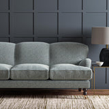 Sofa upholstered in a blue and off-white woven fabric featuring a herringbone pattern.