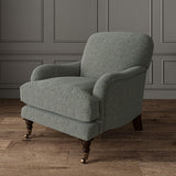 Chair upholstered in a blue and off-white woven fabric featuring a herringbone pattern.