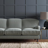 Sofa upholstered in a blue and off-white woven fabric featuring a herringbone pattern.
