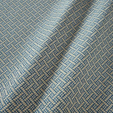 A woven fabric sample in blue and off-white featuring a trellis pattern.