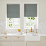 Blinds in blue and off-white woven fabric featuring a trellis pattern.