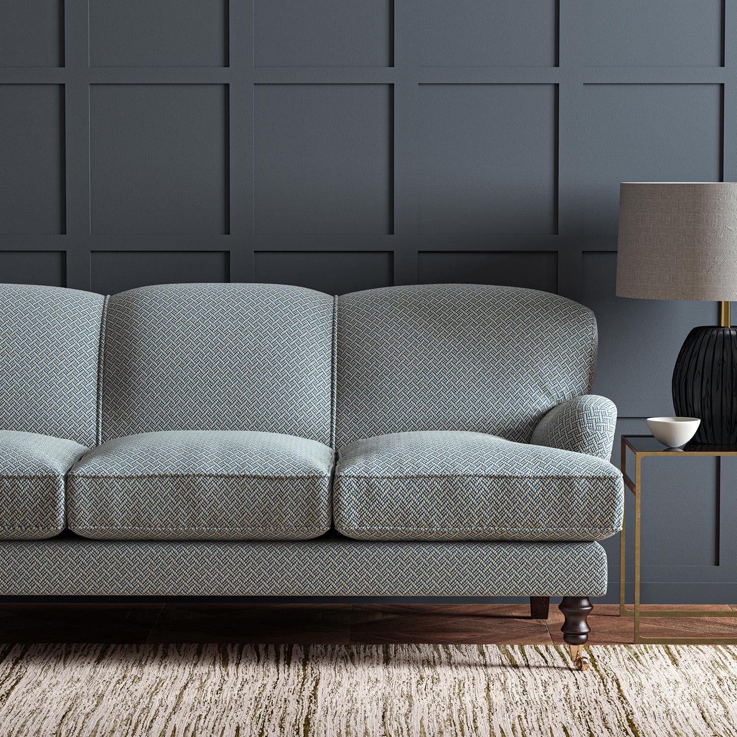 Sofa upholstered in a blue and off-white woven fabric featuring a trellis pattern.