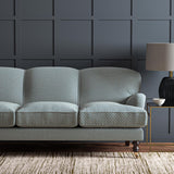 Sofa upholstered in a blue and off-white woven fabric featuring a trellis pattern.