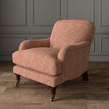 Chair upholstered in a red and off-white woven fabric featuring a geometric pattern.