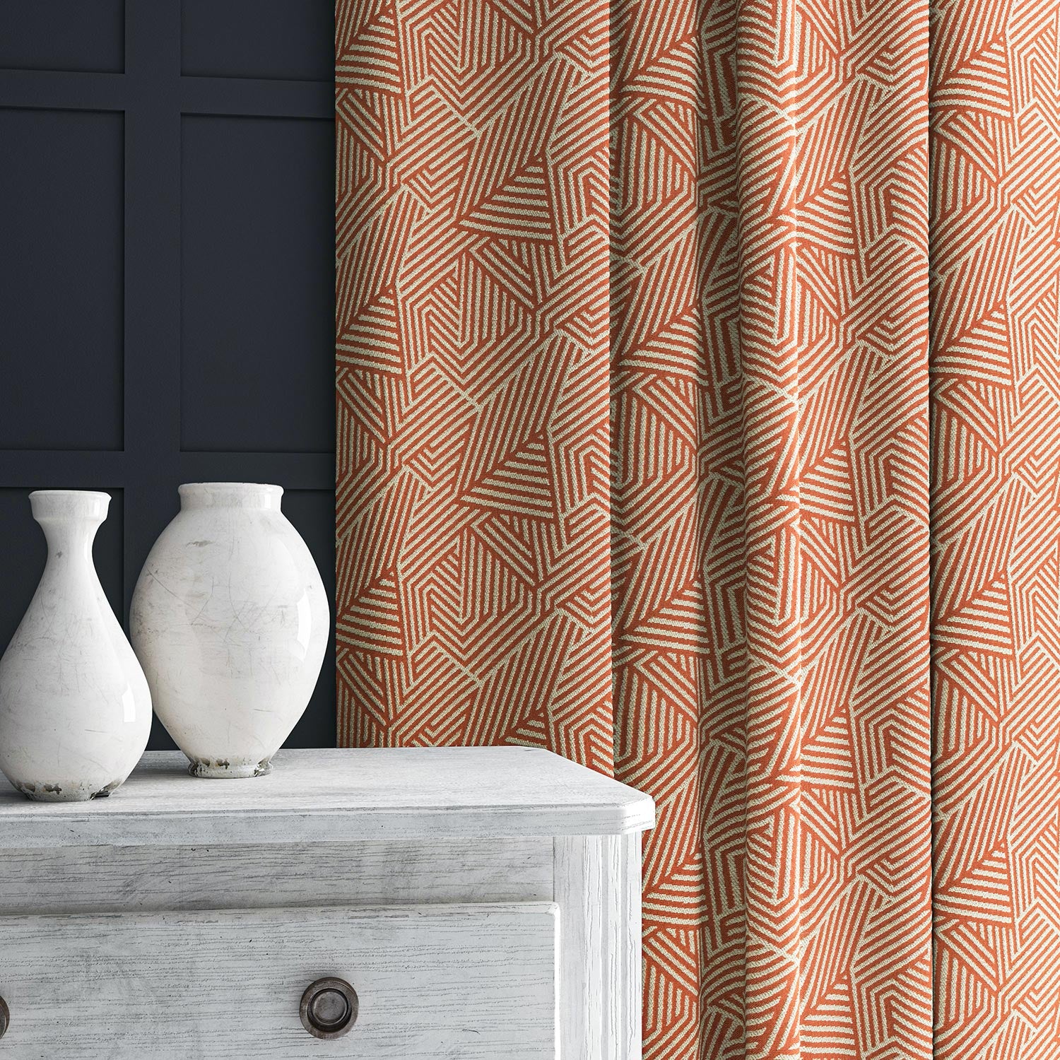 Curtain in red and off-white woven fabric featuring a geometric pattern.