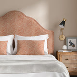 Headboard upholstered in a red and off-white woven fabric featuring a geometric pattern.