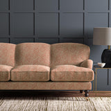 Sofa upholstered in a red and off-white woven fabric featuring a geometric pattern.