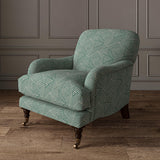 Chair upholstered in a blue and off-white woven fabric featuring a geometric pattern.