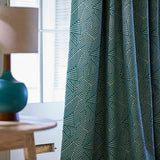 Curtain in a blue and off-white woven fabric featuring a geometric pattern.