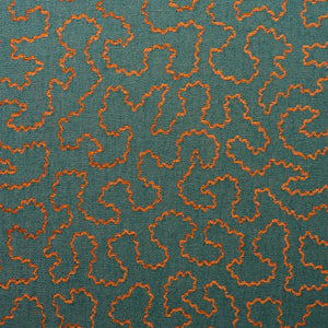 A woven fabric sample in blue and orange featuring a wavy pattern.