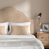 Headboard upholstered in a red and beige woven fabric featuring a wavy pattern.