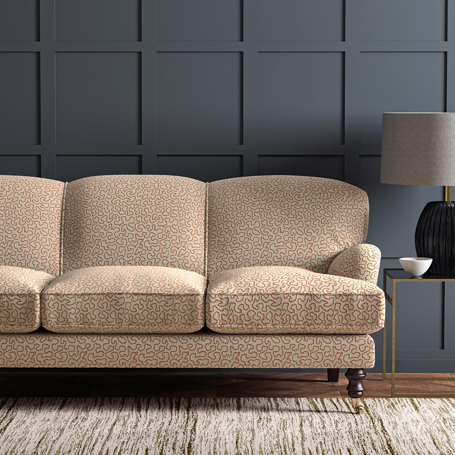 Sofa upholstered in a red and beige woven fabric featuring a wavy pattern.