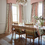 Curtains in a printed linen fabric with pink and green stripes and an oak-leaf motif.