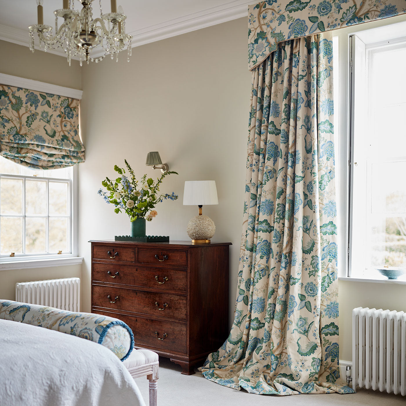 Curtains in a printed linen fabric with tree of life design in blue and green colours.