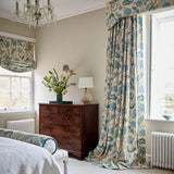 Curtains in a printed linen fabric with tree of life design in blue and green colours.