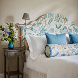 Headboard in a printed linen fabric with tree of life design in blue and green colours.