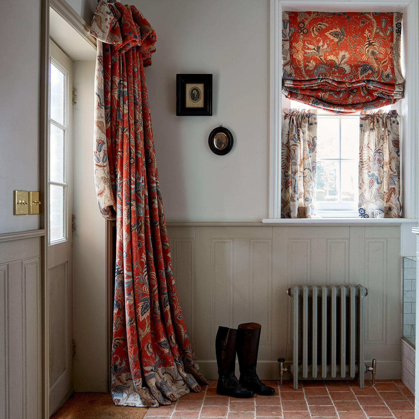 Curtains with a orange fabric with a stylised floral design