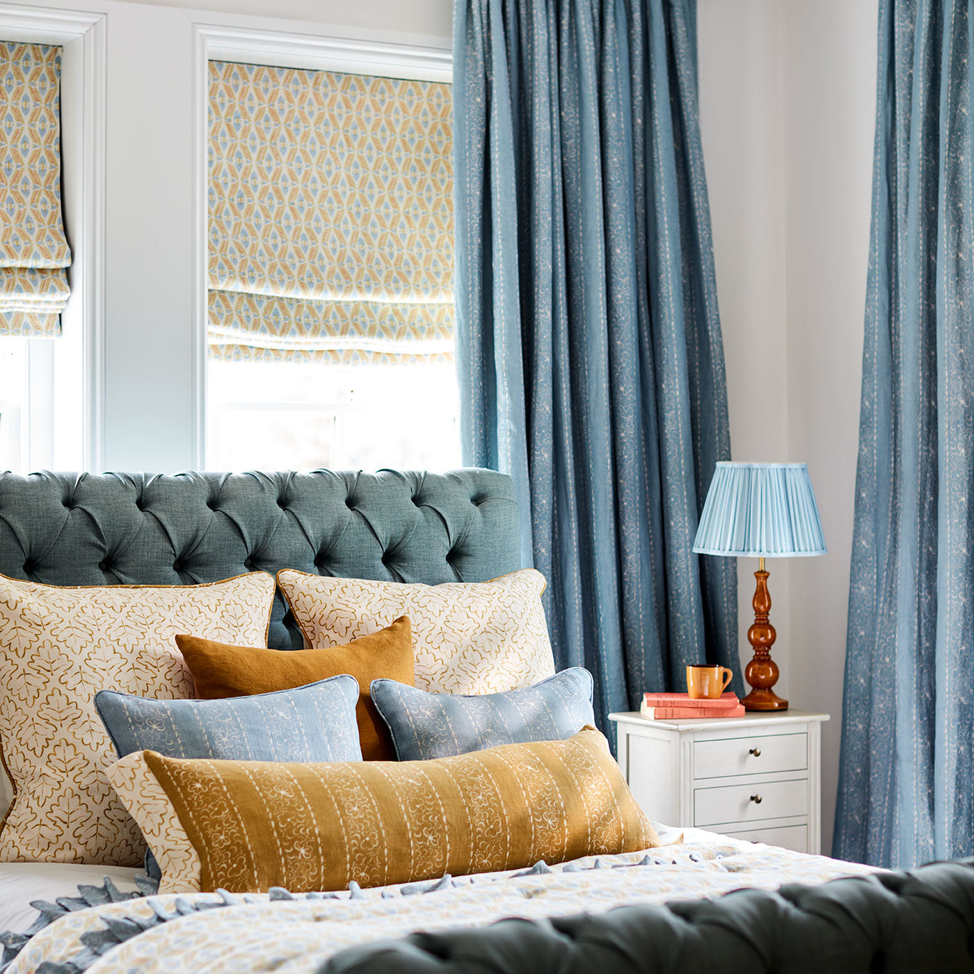 Linen curtains with a delicate pattern of moons and star-like dots in blue and cream