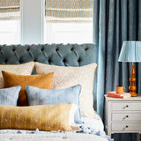 Printed linen fabric – a hand drawn; mirrored leaf motif pattern in yellow and cream – on a cushion