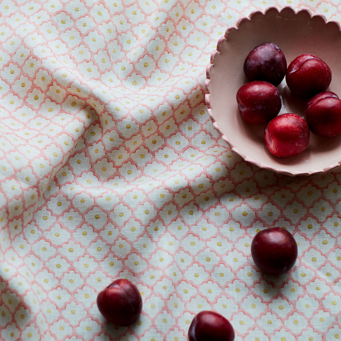 Printed linen fabric sample - a classic trellis design in pink, yellow, and cream