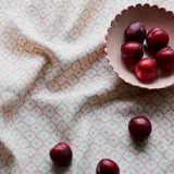 Printed linen fabric sample - a classic trellis design in pink, yellow, and cream