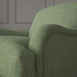 Green chair upholstered in a versatile woven fabric.