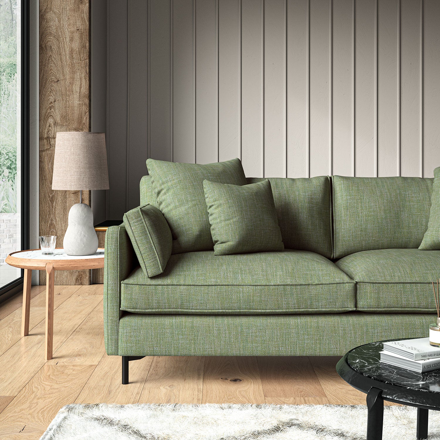 Green sofa upholstered in a versatile woven fabric.